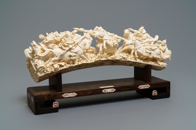 A Chinese carved ivory group with warriors on horseback, 2nd quarter 20th C.
