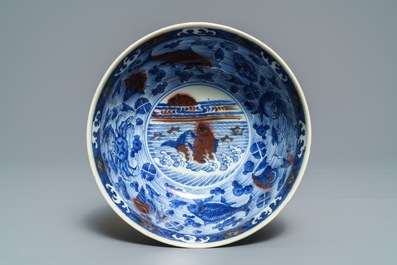 A Chinese blue and underglaze red bowl with carps and marine animals, Xuande mark, Kangxi