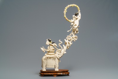 A large Chinese ivory group of an elephant with two ladies, 1st half 20th C.