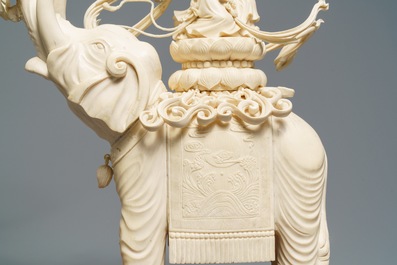 A large Chinese ivory group of an elephant with two ladies, 1st half 20th C.
