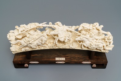 A Chinese carved ivory group with warriors on horseback, 2nd quarter 20th C.