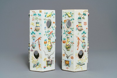 A pair of Chinese famille rose reticulated hat stands with applied designs, 19th C.
