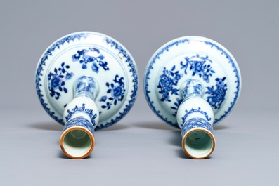 A pair of Chinese blue and white candlesticks, Kangxi/Qianlong