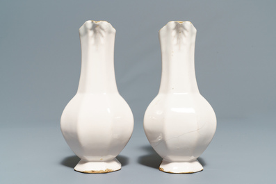 Four white Dutch Delft jugs, a pair of lobed plates and a large shaker, 17/18th C.