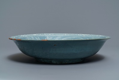 A Chinese Swatow celadon slip-decorated blue-ground dish, Ming