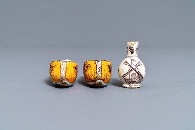 A pair of Dutch Delft polychrome slippers, a miniature jug and a fine lid, 18th C.