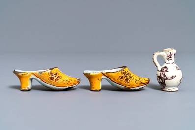 A pair of Dutch Delft polychrome slippers, a miniature jug and a fine lid, 18th C.
