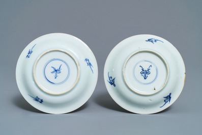 A pair of Chinese blue, white and underglaze red cups and saucers, Kangxi