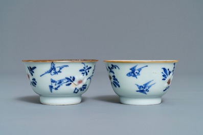 A pair of Chinese blue, white and underglaze red cups and saucers, Kangxi