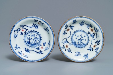 A pair of Chinese blue, white and underglaze red cups and saucers, Kangxi