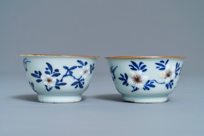 A pair of Chinese blue, white and underglaze red cups and saucers, Kangxi