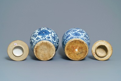 Two Chinese blue and white 'lotus scroll' vases and covers, Kangxi