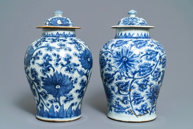 Two Chinese blue and white 'lotus scroll' vases and covers, Kangxi