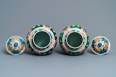A pair of Chinese wucai 'galloping horses' vases and covers, Transitional period