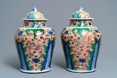 A pair of Chinese wucai 'galloping horses' vases and covers, Transitional period