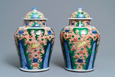A pair of Chinese wucai 'galloping horses' vases and covers, Transitional period