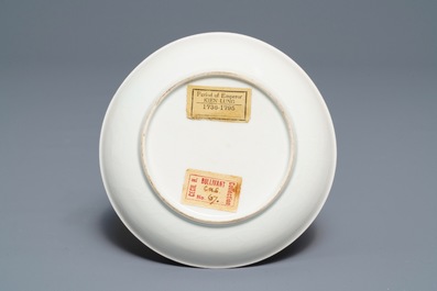 A Chinese blue and white 'soft paste' cup and saucer with an unusual scene with slaves, Qianlong