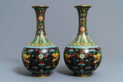 A pair of Chinese cloisonn&eacute; bottle vases, two silver saucers and a silver cup, 19/20th C.