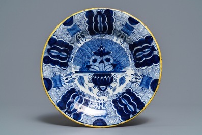 A Dutch Delft blue and white 'peacock's tail' dish and a pair of plates, 18th C.