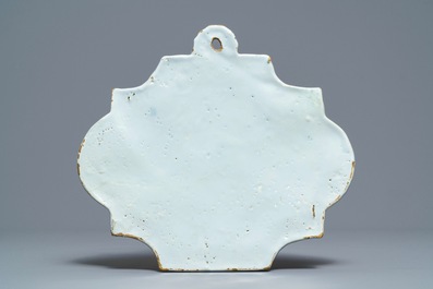 A pair of polychrome Dutch Delft 'Milkmaid' plates and a blue and manganese plaque, 18th C.