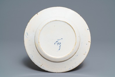A Dutch Delft blue and white 'peacock's tail' dish and a pair of plates, 18th C.
