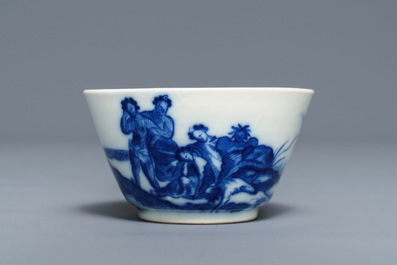 A Chinese blue and white 'soft paste' cup and saucer with an unusual scene with slaves, Qianlong