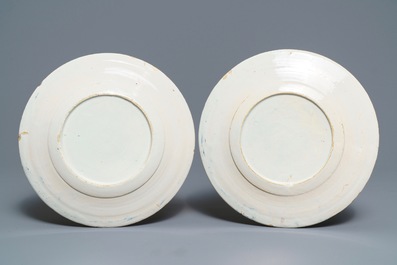 A pair of polychrome Dutch Delft 'Milkmaid' plates and a blue and manganese plaque, 18th C.