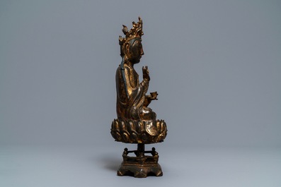 A Chinese gilt-lacquered bronze figure of Guanyin on a lotus throne, Ming