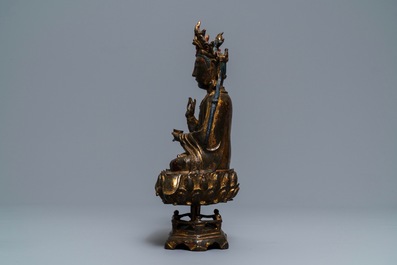 A Chinese gilt-lacquered bronze figure of Guanyin on a lotus throne, Ming