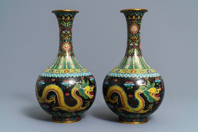 A pair of Chinese cloisonn&eacute; bottle vases, two silver saucers and a silver cup, 19/20th C.