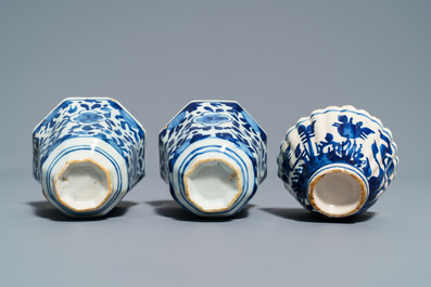 A pair of Dutch Delft blue and white plates, three cups and a saucer, 18th C.