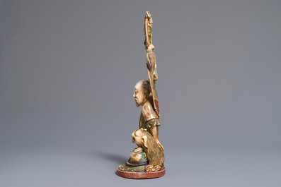 A polychrome Chinese ivory group of a sage with a tiger, 19/20th C.