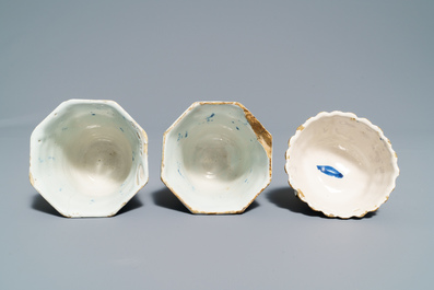 A pair of Dutch Delft blue and white plates, three cups and a saucer, 18th C.