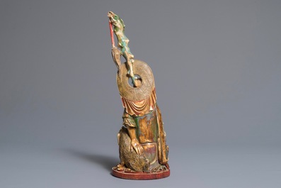 A polychrome Chinese ivory group of a sage with a tiger, 19/20th C.