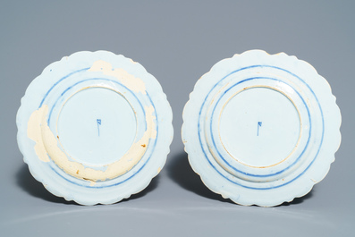 A pair of Dutch Delft blue and white plates, three cups and a saucer, 18th C.
