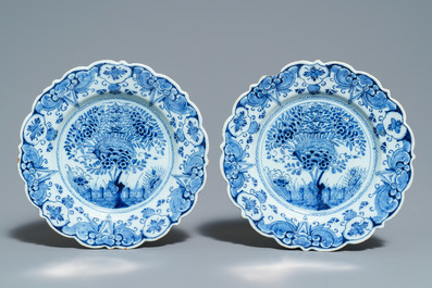 A pair of Dutch Delft blue and white plates, three cups and a saucer, 18th C.