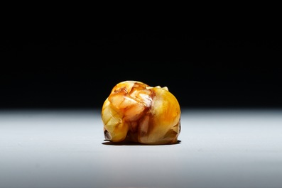 A Chinese celadon and russet jade carving of a tiger, Ming