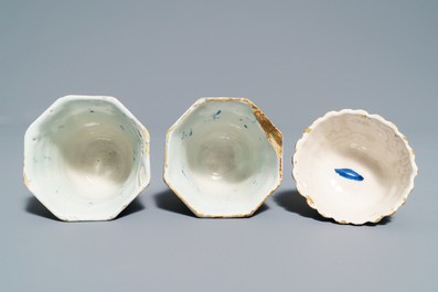 A pair of Dutch Delft blue and white plates, three cups and a saucer, 18th C.