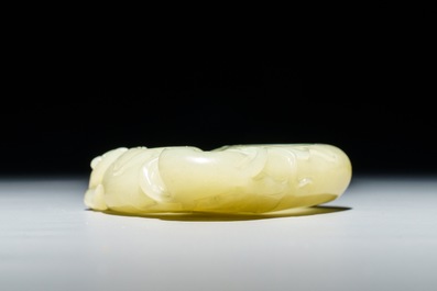 A Chinese celadon jade brush washer with monkeys on peaches, 19/20th C.