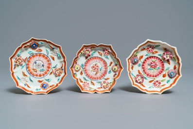 A Chinese famille rose relief-decorated teapot, milk jug and tea caddy on stands, Yongzheng