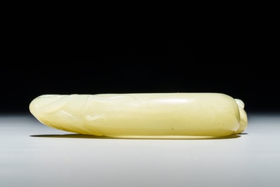 A Chinese celadon jade brush washer with monkeys on peaches, 19/20th C.
