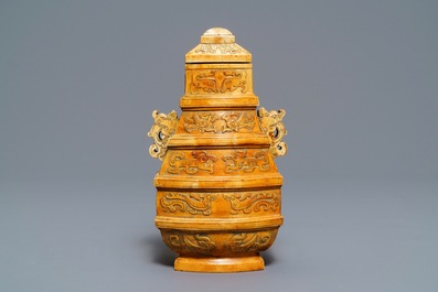 A Chinese archaistic ivory vase and cover on wooden stand, ca. 1900