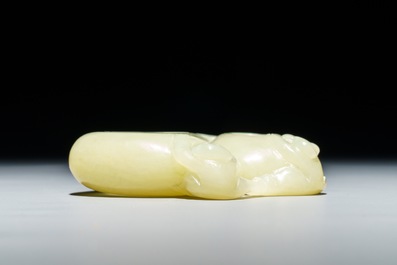 A Chinese celadon jade brush washer with monkeys on peaches, 19/20th C.