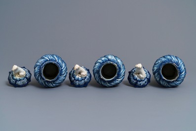 Three Dutch Delft blue and white dog-topped vases and covers, 18th C.