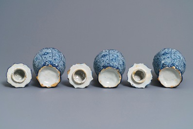 Three Dutch Delft blue and white dog-topped vases and covers, 18th C.