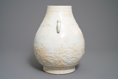 A Chinese monochrome cream-glazed relief-decorated hu vase, Qianlong mark, 20th C.