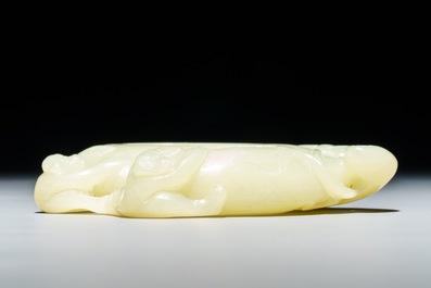A Chinese celadon jade brush washer with monkeys on peaches, 19/20th C.