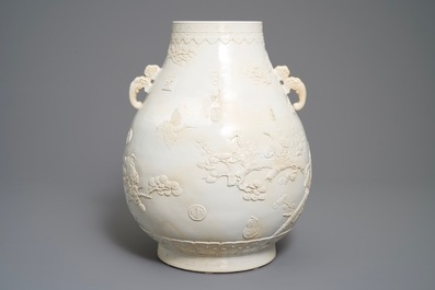 A Chinese monochrome cream-glazed relief-decorated hu vase, Qianlong mark, 20th C.