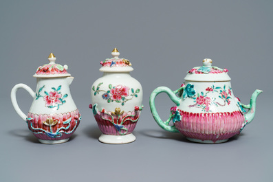 A Chinese famille rose relief-decorated teapot, milk jug and tea caddy on stands, Yongzheng