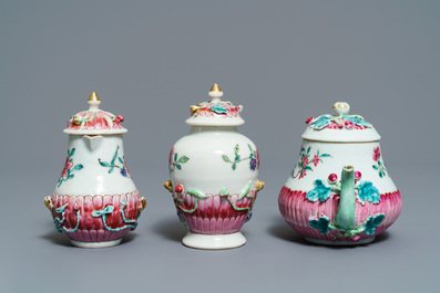 A Chinese famille rose relief-decorated teapot, milk jug and tea caddy on stands, Yongzheng